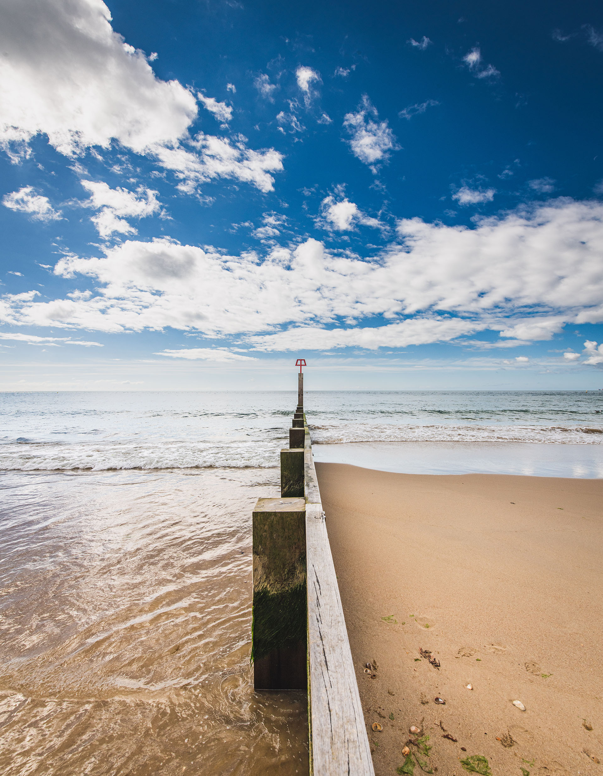 Wooden groyne stretching out from the beach into the sea