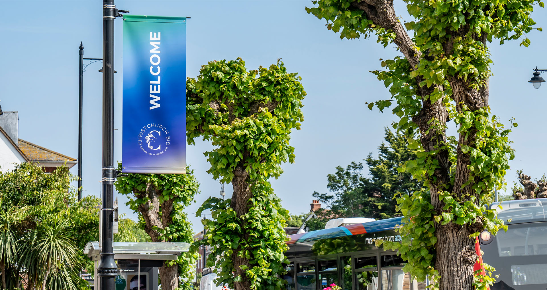 View of a street walkway in Christchurch with a Christchurch BID banner on a lamppost.